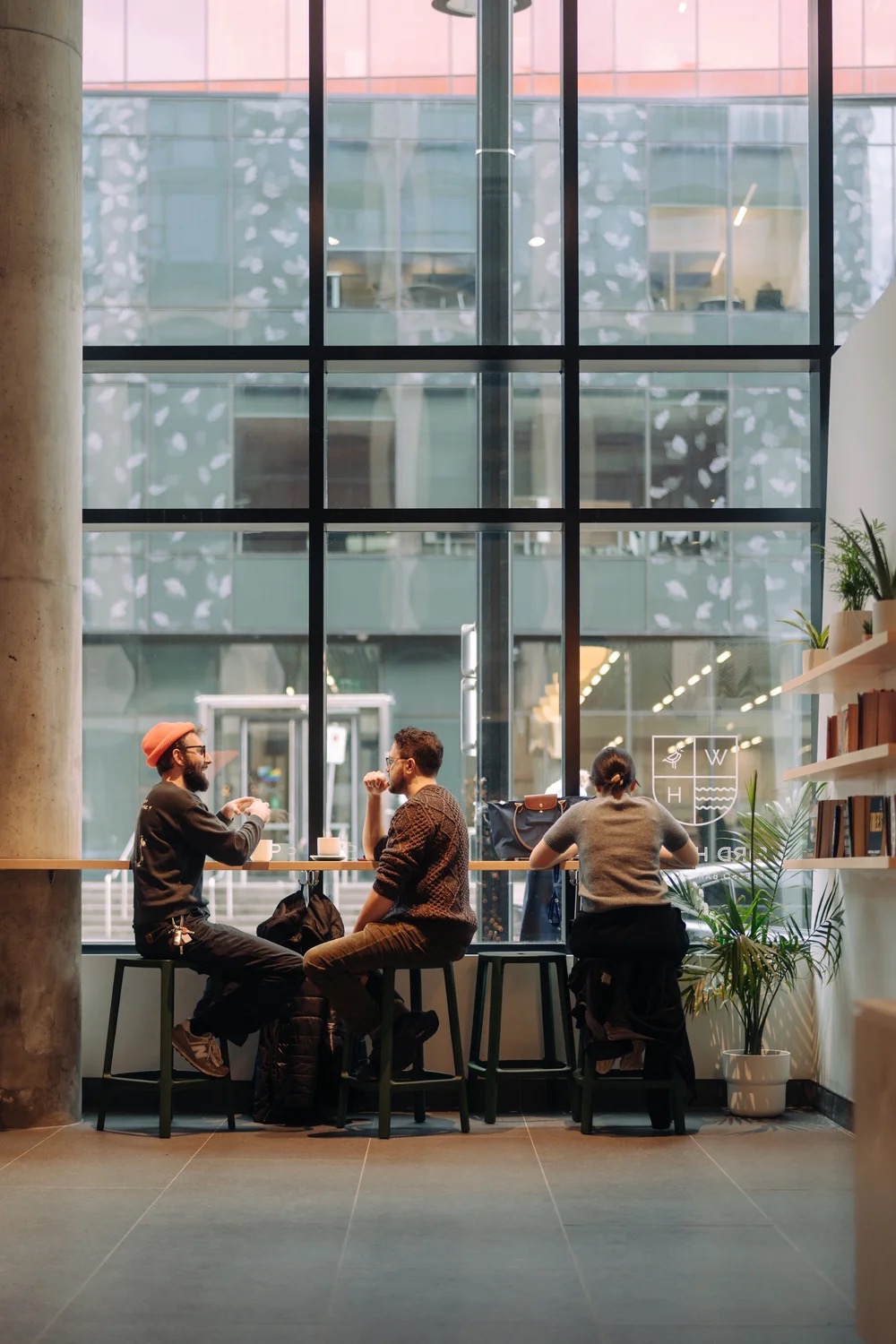 Weird Harbour 2 interior — window bar seating in a bright glass building
